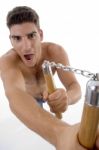 Shouting Man Holding Nunchaku Stock Photo