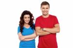 Smiling Couple With Arms Crossed Stock Photo