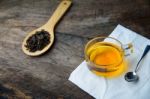 Glass Cup Of Tea And Spoons With Dried Leaves Tea And Green Leav Stock Photo