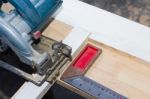 Circular Saw Cutting Wood And Iron Ruler Stock Photo