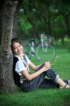 Portrait Of Young Woman With Blur Biclycle Background Relaxing I Stock Photo