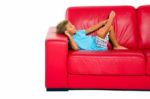 Boy Sleeping On Red Sofa Stock Photo