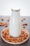 Almond Nuts On Wooden Plate With Milk Stock Photo