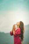 Beautiful Young Attractive  Asian Women In Red Dress On Sunrise Beautiful Nature Background Of The Mountains And Lotus Garden Image Of Happy  Camping, Travel, Lifestyle Resting , Relaxing Concept Vintage Style Stock Photo