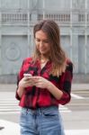 Young Brunette With A Smart Phone Stock Photo