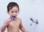 Baby And Toothbrush Stock Photo