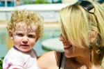 Affectionate Mother Carrying Child Stock Photo