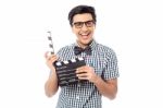 Smiling Man Holding A Movie Clap Stock Photo