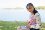 Young Girl With Laptop On The Grass Stock Photo