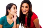 Two Young Girls Gossiping Stock Photo