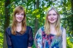 Portrait Of Two Teenage Girls And Trees Background Stock Photo