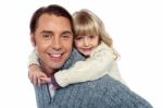 Cute Little Daughter Piggybacking Her Father Stock Photo