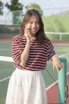 Portrait Of Young Beautiful Asian Woman Talking Smartphone In Te Stock Photo