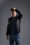 Casual Young Man In Black Leather Jacket And Denim Jeans Stock Photo