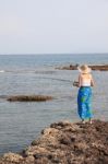 Girl Fishing On Beach Stock Photo