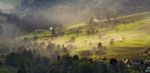 Alpine Village In Mountains. Smoke And Haze Over Hills Stock Photo