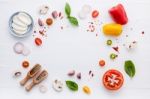 The Ingredients For Homemade Pizza On White Wooden Background Stock Photo