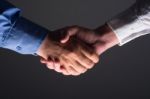 Handshake Handshaking In Dark With Low Light Stock Photo