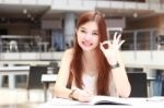 Portrait Of Thai Adult Beautiful Girl Write A Book And Smile In University Stock Photo