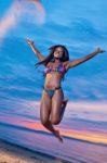 Beautiful Black African American Woman Jumping On The Beach At S Stock Photo