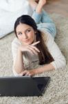 Beautiful Young Woman Working On Her Laptop At Home Stock Photo