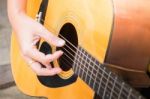 Guitarist Hand Playing Acoustic Guitar Stock Photo