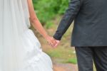 Bride And Groom Walking Away On The Road Stock Photo