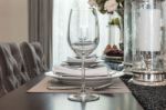 Empty Wine Glass On Wooden Dinning Table With Table Set Stock Photo