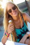 Beautiful Blonde Girl Eating Ice Cream In City Park Stock Photo