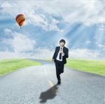 Businessman Running On Road Stock Photo