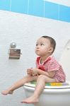 Baby Sitting On Toilet Stock Photo