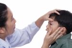 Boy With An Injured Eye. Doctor Examining And First Aid A Patien Stock Photo