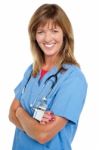 Middle Aged Female Physician With Folded Arms Stock Photo