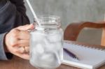 Woman's Hand Holding A Cold Glass Of Water Stock Photo