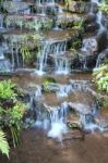 Step Of Small Water Fall In Public Park Stock Photo