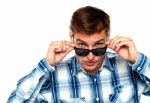 Young Man Adjusting Sunglasses Stock Photo