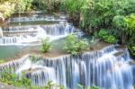 The Water Flowing Over Rocks And Trees Down A Waterfall At Huay Mae Khamin Waterfall National Park ,kanchana Buri In Thailand Stock Photo