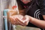 Hands Of Watering The Faucet Stock Photo