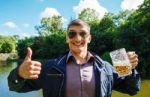 Smiling Man Holding A Large Beer Mug Stock Photo