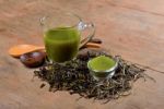 Dried Tea Leaf And Powder With Glass On Wood Stock Photo