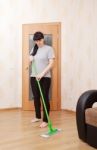 Woman Washes Wooden Floor With A Mop Stock Photo