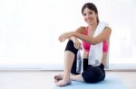 Beautiful Young Woman Drinking Water After A Workout At Home Stock Photo