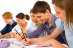 Teenage students Writing On book Stock Photo