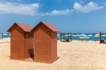 Two Wooden Beach Cabins On Greek Sand Coast Stock Photo