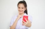 Portrait Of Thai High School Student Uniform Beautiful Girl Using Her Smart Phone Selfie Stock Photo