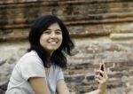 Asian Woman Posing While Holding A Cellphone Stock Photo