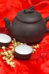 Jasmine Tea Over Red Silk Stock Photo