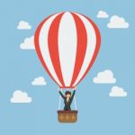 Business Woman Celebrating In Hot Air Balloon Stock Photo