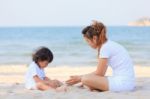 Asian Family Play Sand On Beach Stock Photo