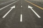 Traffic Sign On Black Asphalt Road Stock Photo